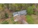 Aerial view of home showcasing mature trees and a long driveway to the house at 1074 Whooping Creek Rd, Carrollton, GA 30116