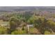 Aerial view of the home on the wooded acreage at 1074 Whooping Creek Rd, Carrollton, GA 30116