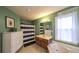 Bright bathroom with a blue striped shower curtain, tile flooring, and wooden vanity at 1074 Whooping Creek Rd, Carrollton, GA 30116