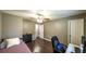 Bedroom with a twin bed, ceiling fan, dark wood flooring and an adjacent space at 1074 Whooping Creek Rd, Carrollton, GA 30116