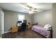 Bedroom featuring a twin bed, dark wood flooring, desk, ceiling fan and large window at 1074 Whooping Creek Rd, Carrollton, GA 30116