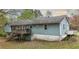 Exterior elevation of the home with a deck overlooking backyard at 1074 Whooping Creek Rd, Carrollton, GA 30116