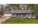 Charming single Gathering home with blue siding, front porch, and attached two-car garage at 1074 Whooping Creek Rd, Carrollton, GA 30116