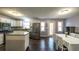 Bright kitchen with island, stainless appliances, dining table, and hardwood floors at 1074 Whooping Creek Rd, Carrollton, GA 30116