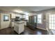 Bright kitchen with white cabinets, stainless steel appliances, kitchen island, and hardwood floors at 1074 Whooping Creek Rd, Carrollton, GA 30116