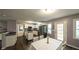 Spacious kitchen with a kitchen island, stainless appliances, dining table and hardwood floors at 1074 Whooping Creek Rd, Carrollton, GA 30116