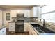 Updated kitchen features stainless steel appliances, granite countertops and modern backsplash at 1074 Whooping Creek Rd, Carrollton, GA 30116