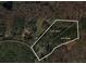 Aerial view of property lines for 5.25 acres of land with mature trees at 1074 Whooping Creek Rd, Carrollton, GA 30116