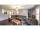 Open living room with access to the kitchen, dining area, and ample natural light at 1074 Whooping Creek Rd, Carrollton, GA 30116