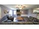 Open concept living room, hardwood floors, stone fireplace, and access to kitchen at 1074 Whooping Creek Rd, Carrollton, GA 30116