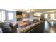 Open-concept living room with a stone fireplace, hardwood floors, and natural light at 1074 Whooping Creek Rd, Carrollton, GA 30116