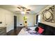 Comfortable main bedroom featuring wood floors, a ceiling fan, a window, and ensuite access at 1074 Whooping Creek Rd, Carrollton, GA 30116