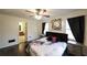 Inviting main bedroom with dark wood floors, ceiling fan, and ensuite bathroom access at 1074 Whooping Creek Rd, Carrollton, GA 30116