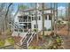 Stunning back exterior featuring a screened-in porch, a spacious deck, and a lush, terraced yard at 1270 Smokehouse Trl, Cumming, GA 30041