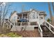Multi-level backyard with a large deck, screened porch, and stairs leading to different areas at 1270 Smokehouse Trl, Cumming, GA 30041