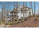 Multi-level backyard with a large deck, screened porch, and stairs leading to different areas at 1270 Smokehouse Trl, Cumming, GA 30041