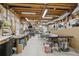 Spacious basement workshop featuring exposed beams and an array of tools and equipment at 1270 Smokehouse Trl, Cumming, GA 30041