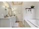 Bright bathroom featuring a soaking tub and a double vanity with granite countertops at 1270 Smokehouse Trl, Cumming, GA 30041