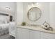 A serene bathroom, complete with a round mirror, leads into a cozy bedroom with a crib at 1270 Smokehouse Trl, Cumming, GA 30041