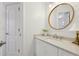 Bright bathroom with a round mirror, granite countertops, and white cabinets at 1270 Smokehouse Trl, Cumming, GA 30041