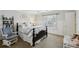 Cozy bedroom with a dark wood bed frame, wainscoting and a rocking chair at 1270 Smokehouse Trl, Cumming, GA 30041