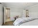 Bright bedroom showcasing wainscoting, a bed with a blue and white comforter, and two doorways at 1270 Smokehouse Trl, Cumming, GA 30041