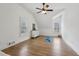 Bright bedroom with wood floors, white walls, multiple windows, and a ceiling fan at 1270 Smokehouse Trl, Cumming, GA 30041