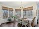 Sunlit breakfast nook with a table, chairs, pendant lighting, and nature views at 1270 Smokehouse Trl, Cumming, GA 30041