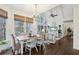 Charming dining area with chandelier, vaulted ceiling, large windows with wooded views, and hardwood floors at 1270 Smokehouse Trl, Cumming, GA 30041