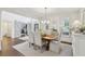 The dining room features a wooden table, chairs, chandelier, and access to other rooms at 1270 Smokehouse Trl, Cumming, GA 30041