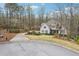 Charming two-story home featuring a well-manicured lawn, lush landscaping, and a welcoming driveway in wooded area at 1270 Smokehouse Trl, Cumming, GA 30041