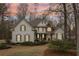 Stately home with stone accents, dormer windows, and a welcoming front porch at 1270 Smokehouse Trl, Cumming, GA 30041