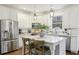Bright kitchen with white cabinets, stainless steel appliances, and white marble countertops at 1270 Smokehouse Trl, Cumming, GA 30041