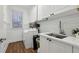 Bright laundry room featuring white cabinets, countertops, modern appliances, and ample storage space at 1270 Smokehouse Trl, Cumming, GA 30041