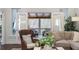 Living room with French doors leading to screened porch offering wooded view at 1270 Smokehouse Trl, Cumming, GA 30041