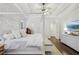 Airy primary bedroom boasts white walls, hardwood floors, a canopy bed, and contemporary furnishings at 1270 Smokehouse Trl, Cumming, GA 30041