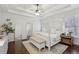 Bright primary bedroom with white walls, a canopy bed, dark wood floors, and bright natural light at 1270 Smokehouse Trl, Cumming, GA 30041