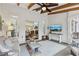 This is a bright sunroom with comfortable seating, a ceiling fan, and an open access at 1270 Smokehouse Trl, Cumming, GA 30041