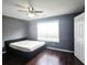 Bedroom featuring a large window, hard wood floors and a dark grey paint at 2675 Sardis Chase Ct, Buford, GA 30519