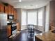A stylish kitchen features wood cabinets, stainless appliances, and an inviting eat-in breakfast area at 2675 Sardis Chase Ct, Buford, GA 30519