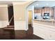 Open-concept living room featuring hardwood floors, kitchen access, and a staircase to the second floor at 2675 Sardis Chase Ct, Buford, GA 30519