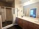 Spacious main bathroom with double vanity, wood cabinets, and a glass-enclosed shower at 2675 Sardis Chase Ct, Buford, GA 30519