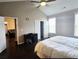 Comfortable main bedroom with a ceiling fan, a desk, and an open doorway to a seating area at 2675 Sardis Chase Ct, Buford, GA 30519