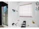 Bright bathroom featuring a jetted tub beneath a large window and a separate glass-enclosed shower at 3287 Shady Valley Ln, Loganville, GA 30052