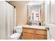 Bathroom features a decorative mirror, granite countertop, wooden cabinets, and a shower with curtain at 3287 Shady Valley Ln, Loganville, GA 30052