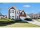 Charming two-story home with a well-maintained lawn and beautiful brick and white siding at 3287 Shady Valley Ln, Loganville, GA 30052