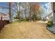 Expansive backyard featuring a patio, lush greenery, and plenty of space for outdoor activities and enjoyment at 4015 Embassy Way, Lilburn, GA 30047