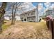 Large backyard with mature trees and a patio, providing ample space for recreation and relaxation at 4015 Embassy Way, Lilburn, GA 30047