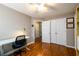 Bedroom with wood floors, closet, and desk, providing an ideal workspace at 4015 Embassy Way, Lilburn, GA 30047