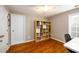 Charming bedroom boasts hardwood floors, ceiling fan, and built-in bookcase at 4015 Embassy Way, Lilburn, GA 30047